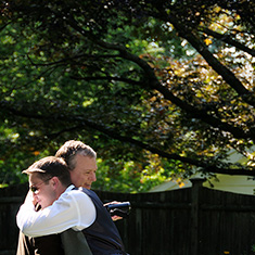 Groom embracing guest