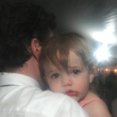 Wedding guest father holding baby