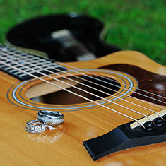 Wedding rings displayed on guitars