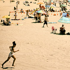 Girl running on beach, Coney Island, New York City