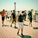 A group of pedestrians turning in curiosity on the Coney Island Boardwalk, New York City